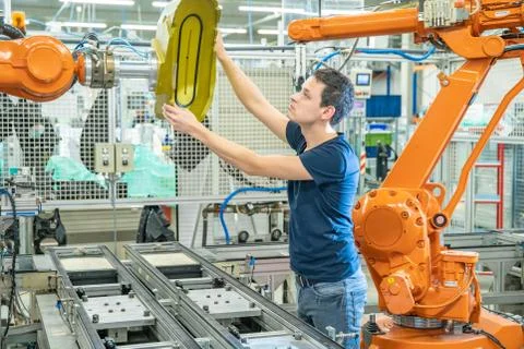 Setting up a robotic line with automatic arms before starting the process 스톡 사진