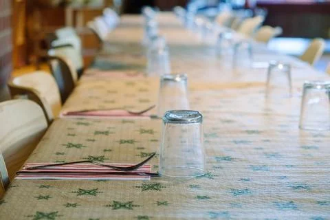 Setting a simple Christmas table with cutlery and glasses for a festive gatherin Stock Photos