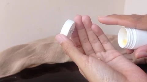 Setting a small pink stapler with hand Stock Footage 146255825