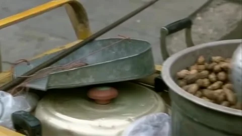Setting up a stall selling boiled peanuts Stock Footage 253773781