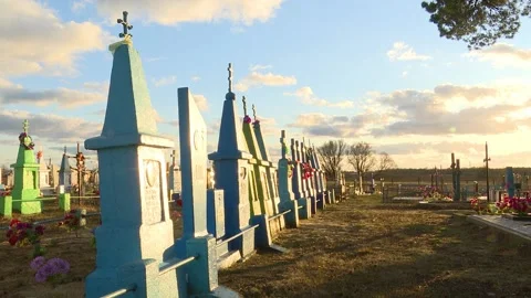 The setting sun against a cloudy sky, an old cemetery, a time lapse.  Stock Footage 150257017
