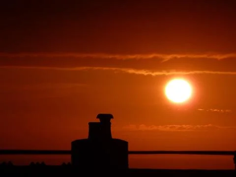 Setting sun and chimney Stock Photos