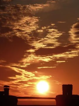 Setting sun and clouds Stock Photos