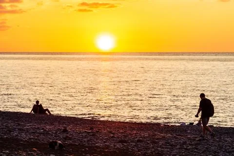 Setting sun and pebble beach in Batumi in autumn Stock Photos