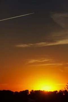 Setting sun and sky with clouds Stock Photos