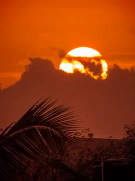 Setting sun behind the clouds Stock Photos
