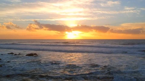 Setting sun behind clouds reflected on the ocean in summer Stock Footage 95133455