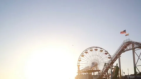 Setting Sun Behind Ferris Wheel on Santa Monica Pier Stock Footage 71900874