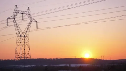 Setting sun behind horizon under high voltage power lines Stock Footage 157007576