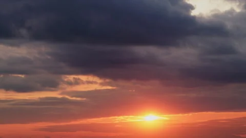 The setting sun casts long shadows across the landscape, adding depth and Video stock 256426359