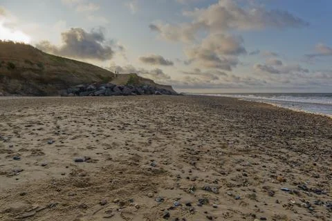 Setting sun casts a warm glow across Happisburgh beach Stock Photos