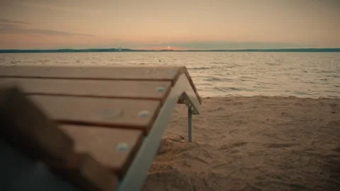 Setting sun creating warm colors in the sky over rippling water Video stock 292868931