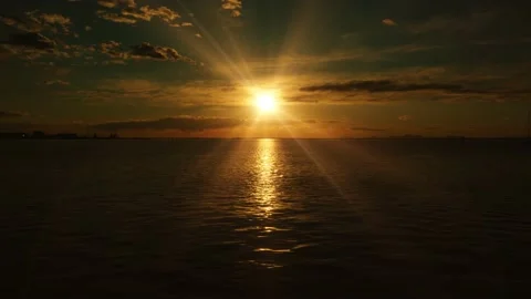 Setting sun disk lights Venetian lagoon dark rippling water 스톡 동영상 151296329