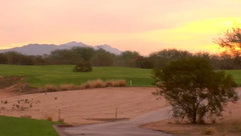 Setting sun golf course with mountains Stock Footage 125278451