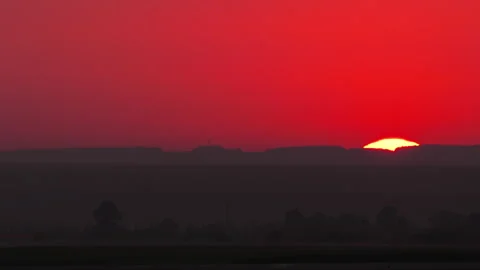 Setting sun in hills and red sky Stock Footage 281945080