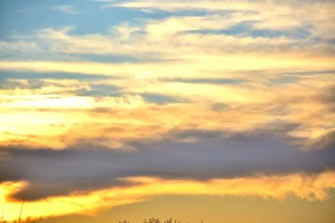 The setting sun illuminated the clouds with a bright orange light.	 Stock Photos