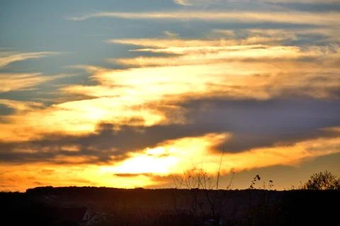 The setting sun illuminated the clouds with orange light.	2 Stock Photos