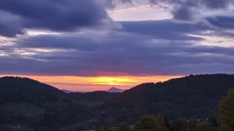 The setting sun illuminates the beautiful autumn forest mountain landscape Stock Footage 219610525