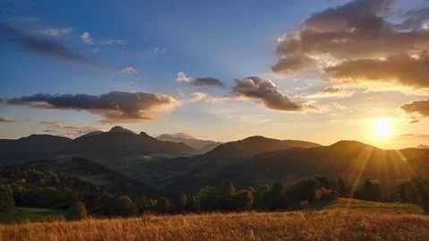 The setting sun illuminates the beautiful rural mountain landscape. Autumn Stock Footage 219610435