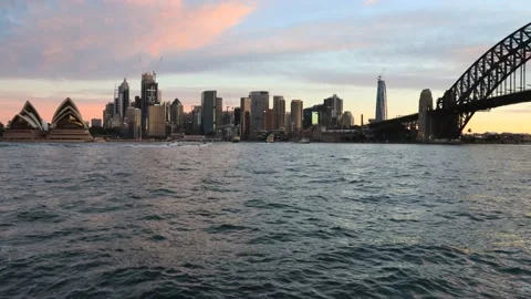 Setting sun light over Sydney harbour and Bridge with city CBD – 4k timelapse. Stock Footage 135649482