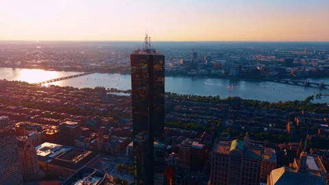 Setting sun lights the vast panorama of Boston, Massachusetts, USA. Flying past Stock Footage 344044025