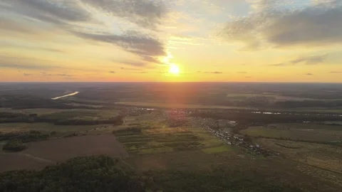 Setting sun, moving camera glare, aerial views of the countryside Stock Footage 254078400