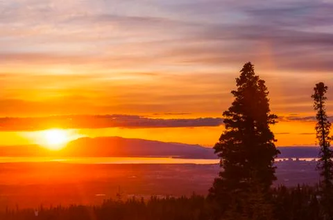 The setting sun over Alaskas Mount Susitna, locally known as The Sleeping Lady Stock Photos