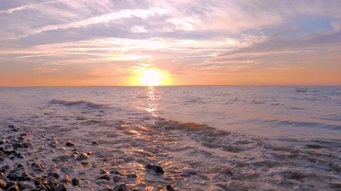 The setting sun over beach 스톡 동영상 77852541