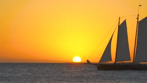 Setting Sun Over Florida Keys Ocean Closeup Sailboat Sails Through Stock Footage 256051121