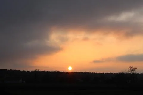 Setting sun over the forest Stock Photos