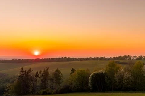 The setting sun over the forested mountain landscape of the Beskydy region, t 스톡 사진