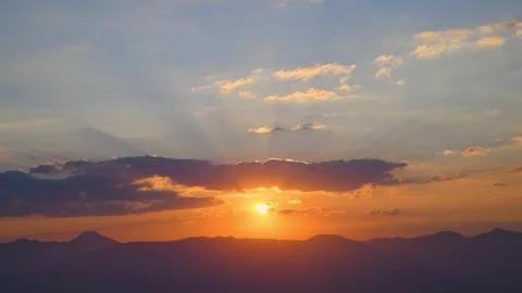 The setting sun over the mountains, the beautiful sun's rays shine through the Stock Footage 281511474