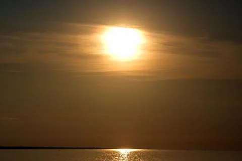 The setting sun over the sea. Reflection of sunlight in the water. Gulf of Fi 写真素材