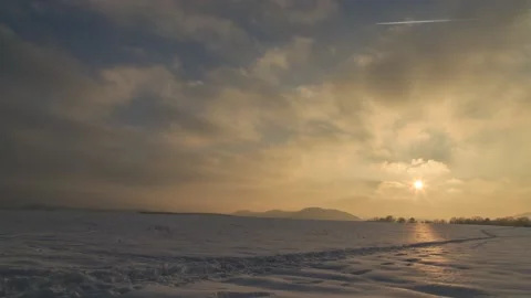 Setting sun over snow covered field,4k,timelapse Stock Footage 230652564