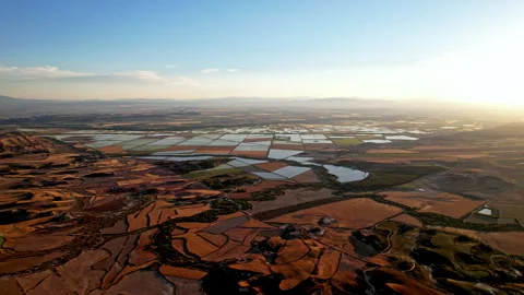 The setting sun over Spain's patchwork of agriculture and arid land. Stock Footage 257337196