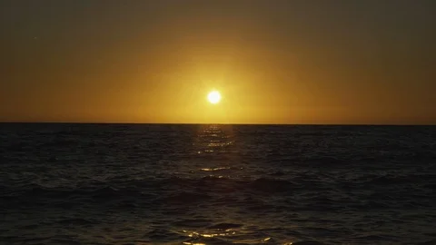 Setting sun paints the sky yellow at the sea Video stock 125214203