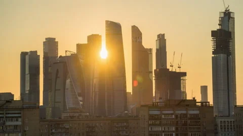 The setting sun passes through the skyscrapers of Moscow City Stock Footage 153080643