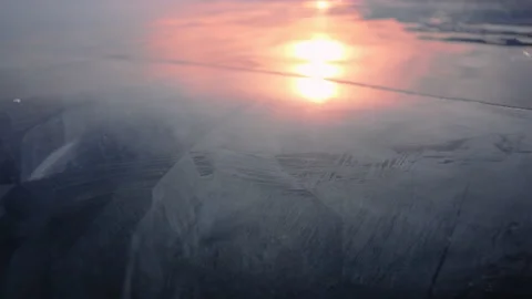 The setting sun is reflected in the ice of Lake Baikal Stock Footage 170761424
