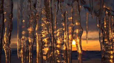 Setting sun is reflected in icicles 스톡 사진