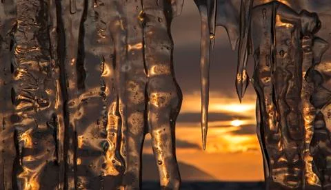 Setting sun is reflected in icicles Stock-Fotos