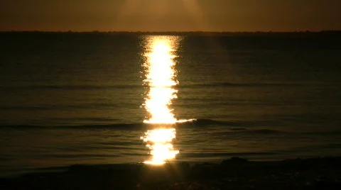 Setting sun is reflected in the rippling water (High Definition) Stock Footage 364812