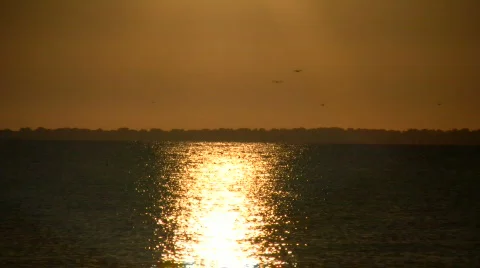 Setting sun is reflected in the rippling water (High Definition) Stock Footage 364813