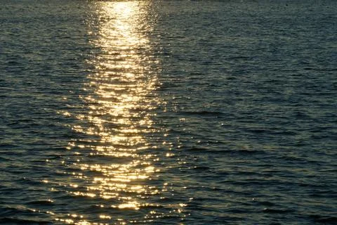 The setting sun is reflected in the water Stock Photos