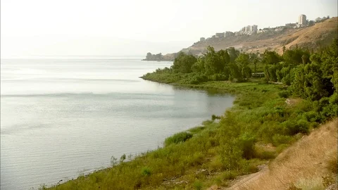 Setting sun reflecting off of surface of Sea of Galilee 動画素材 95600680