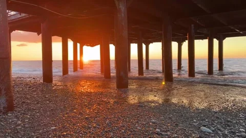 Setting sun on seashore. Pebble beach Batumi Stock Footage 250636538