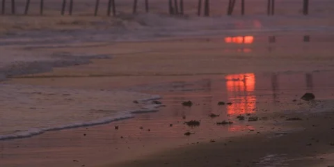 Setting sun seen through the pier Stock Footage 103492401
