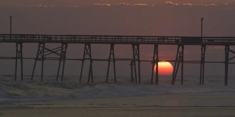 Setting sun seen through the pier Stock Footage 103492444