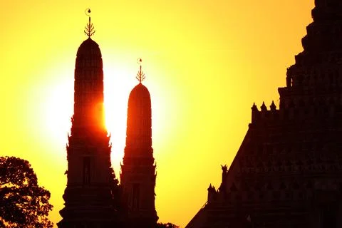 Setting Sun Shining Through the Silhouette of Wat Arun Temple, Bangkok, Thailand Stock Photos