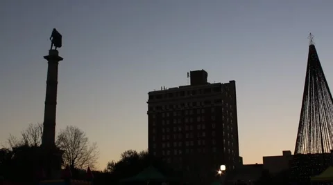 Setting Sun Silhouettes Christmas Tree and Building  Stock Footage 45564356