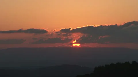 Setting sun (sped up) in Israel sinks behind mountains Video stock 49455291
